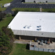 Aerial view of a building with a white metal roof