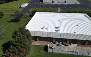 Aerial view of a building with a white metal roof